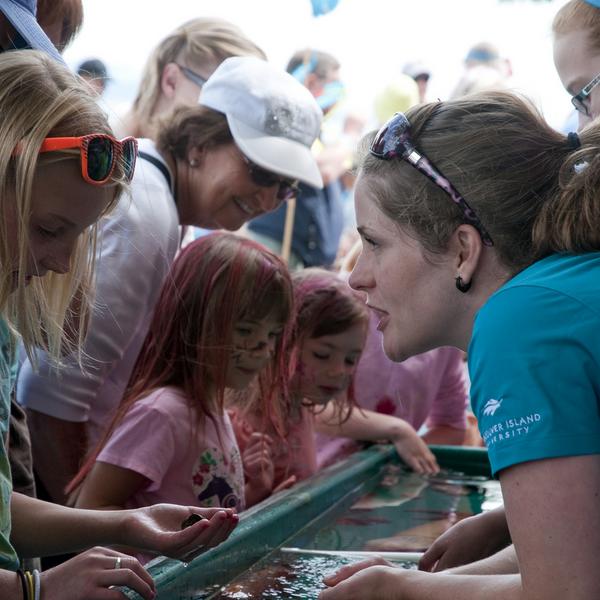 Volunteer at a touch tank with students